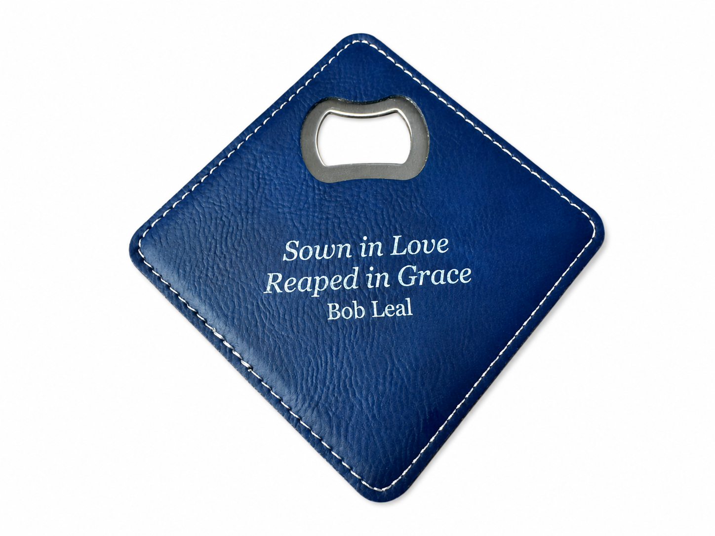Finished navy-blue Sown in Love, Reaped in Grace memorial coaster for Bob Leal on a clean white background